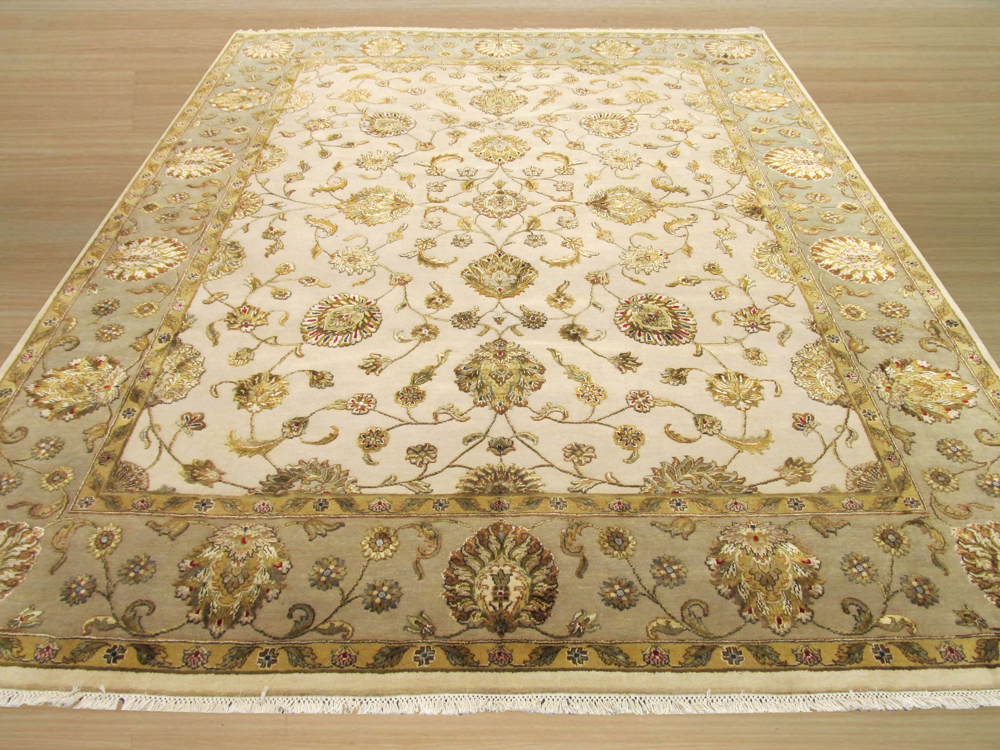 Cassandra Oriental Multicolor Hand Knotted Wool & Silk Rug displayed, its vibrant hues and intricate hand-knotted details softening a neutral space with light wooden floors.
