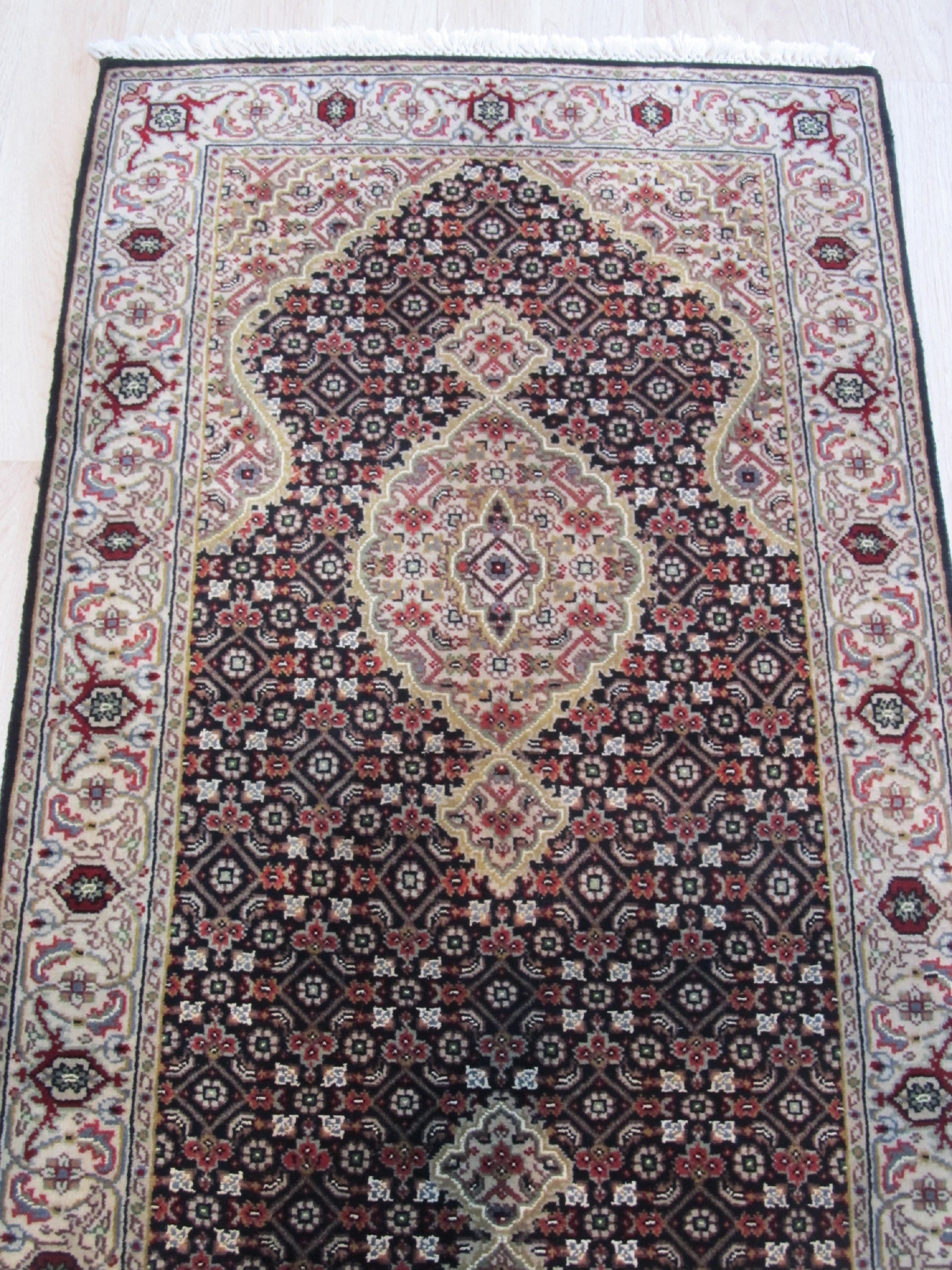 Elena Versatile Brown Hand Knotted Wool Rug, warm browns and intricate geometric patterns play across the hand-knotted wool pile, lending texture and sophistication to a modern living space.