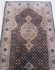 Elena Versatile Brown Hand Knotted Wool Rug, warm browns and intricate geometric patterns play across the hand-knotted wool pile, lending texture and sophistication to a modern living space.