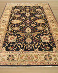 Ella Isla Multicolor Hand Knotted Wool & Silk Rug, its vibrant threads blooming across a warm wooden floor, offering a luxurious splash of color to a sun-drenched living space.