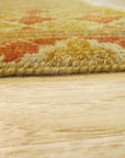 Mira Agra Multicolor Hand Knotted Wool Rug, vibrant hues dance across a textured wool surface; a hand-knotted masterpiece seen in a warmly lit interior setting.