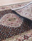 Ophelia Amara Brown Hand Knotted Wool Rug, a warm, earthy brown wool rug with a subtle, intricate hand-knotted design, graces a modern living space.