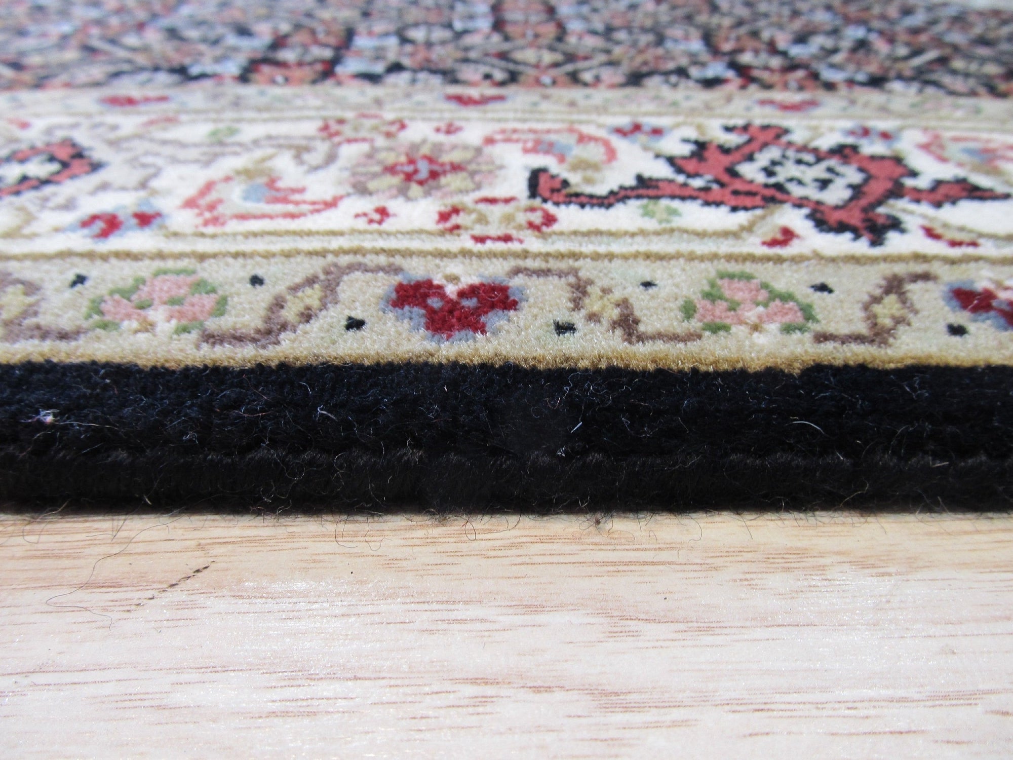 Ophelia Amara Brown Hand Knotted Wool Rug, a warm brown hand-knotted wool rug with subtle geometric patterns, partially visible in a styled living room setting.