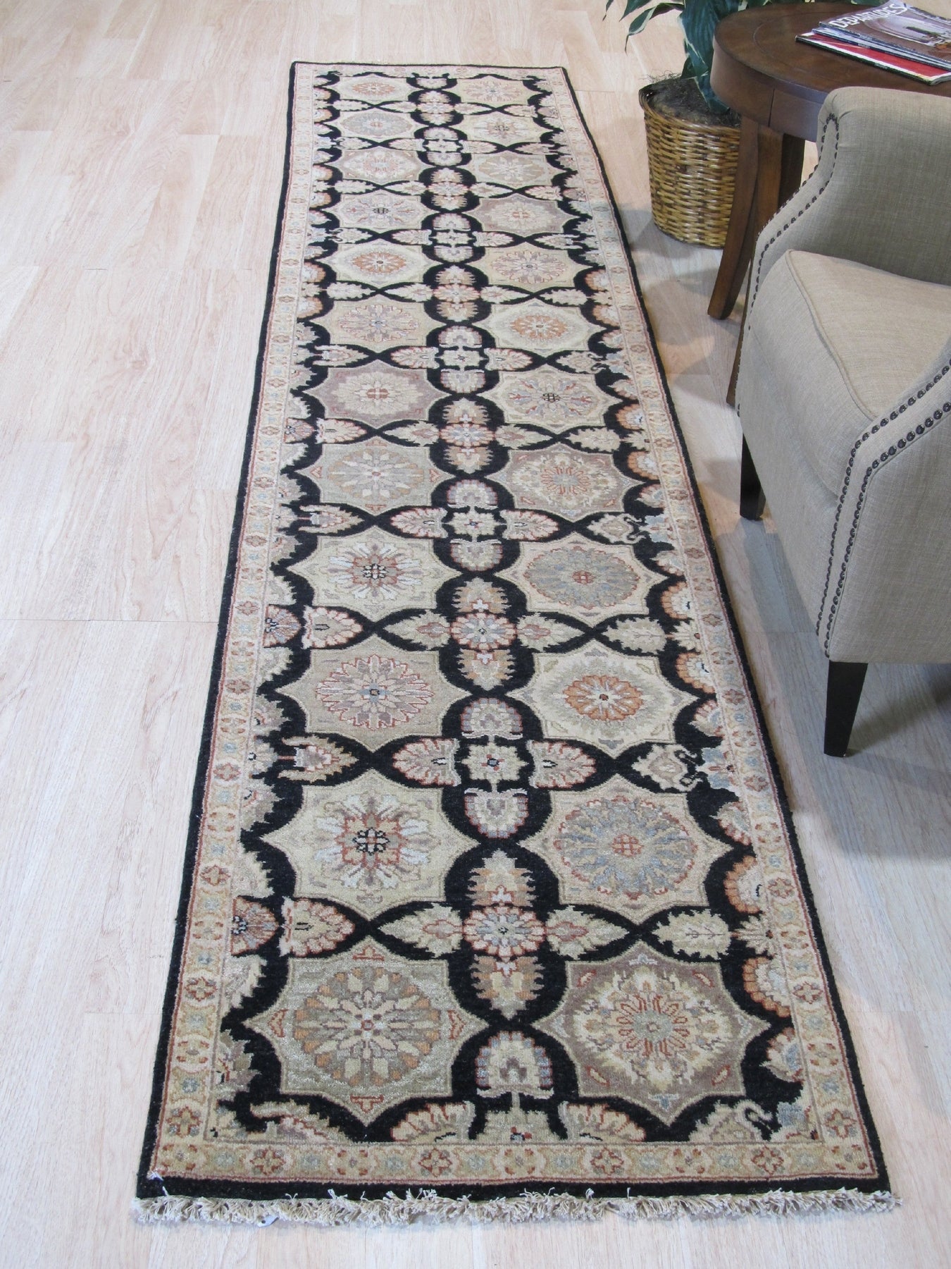 Hand knotted wool Timeless Agra Black Rug, its intricate pattern richly displayed on the floor. Deep black wool creates a foundation for the ornate, traditional Agra design. Subtle variations in shading add depth and character to the luxurious pile.