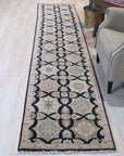 Hand knotted wool Timeless Agra Black Rug, its intricate pattern richly displayed on the floor. Deep black wool creates a foundation for the ornate, traditional Agra design. Subtle variations in shading add depth and character to the luxurious pile.