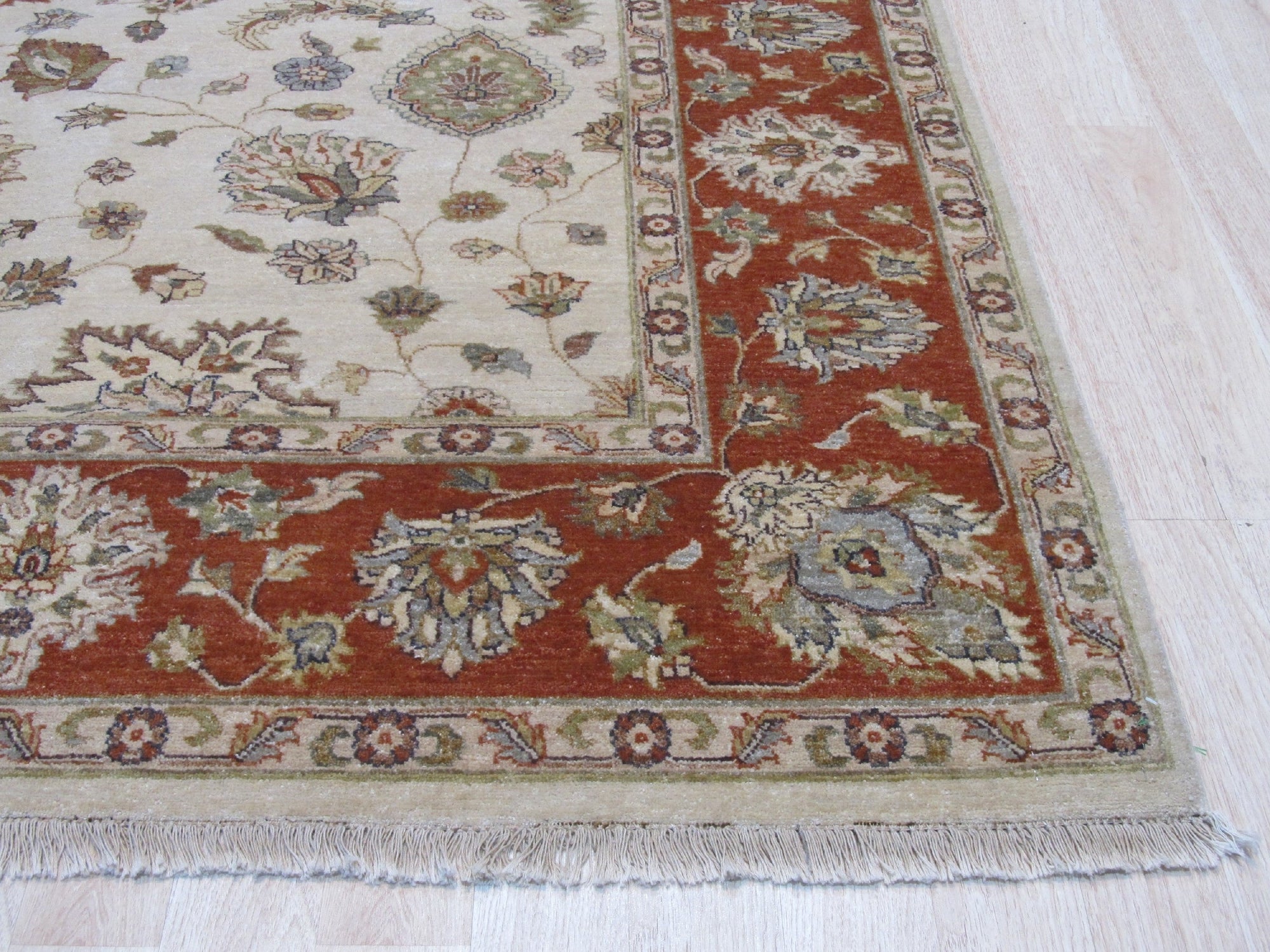 Exquisite Agra Multicolor Hand Knotted Wool Rug, a vibrant array of blues, reds, greens, and yellows woven into a detailed pattern, displayed within a warmly lit living space featuring contemporary furniture.