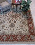 Exquisite Agra Multicolor Hand Knotted Wool Rug displays a vibrant tapestry of jewel-toned hues and intricate floral patterns, its plush wool texture inviting touch, seen in a cozy living space.