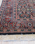 Sleek Oriental Navy Hand Knotted Wool Rug anchors a bright, modern living room; intricate navy and beige patterns on hand-knotted wool provide a luxurious and subtly textured foundation beneath contemporary furniture.