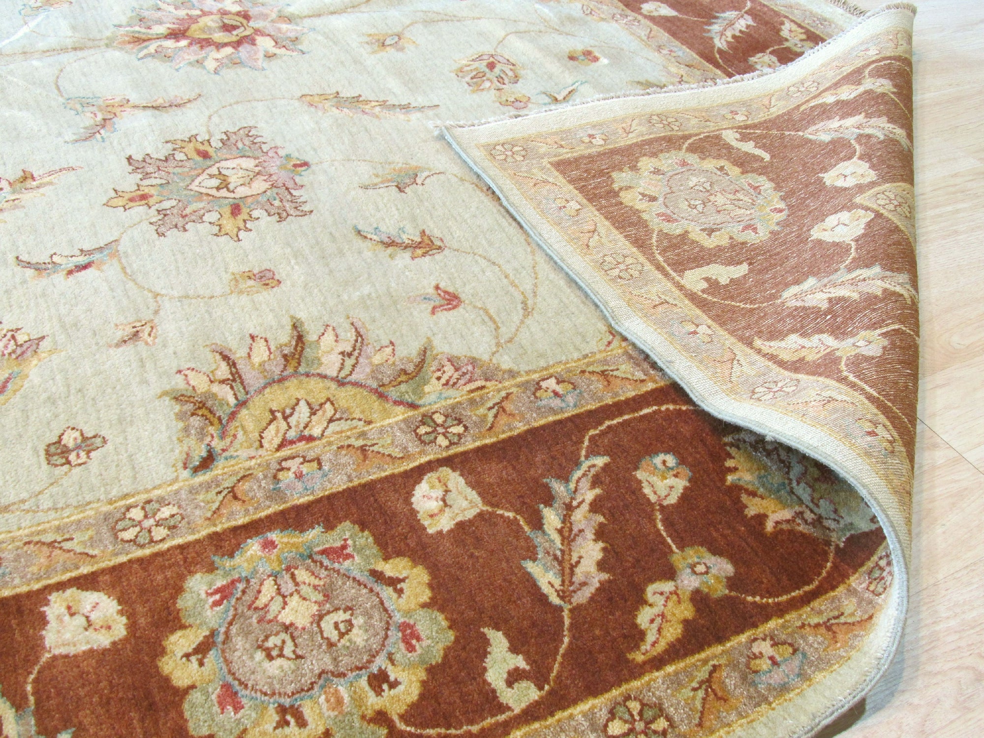 Alluring Artisan Multicolor Hand Knotted Wool Rug displayed in a living room setting; vibrant hues dance across its hand-knotted surface, complementing the warm, inviting space.