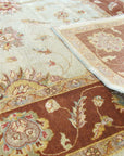 Alluring Artisan Multicolor Hand Knotted Wool Rug displayed in a living room setting; vibrant hues dance across its hand-knotted surface, complementing the warm, inviting space.