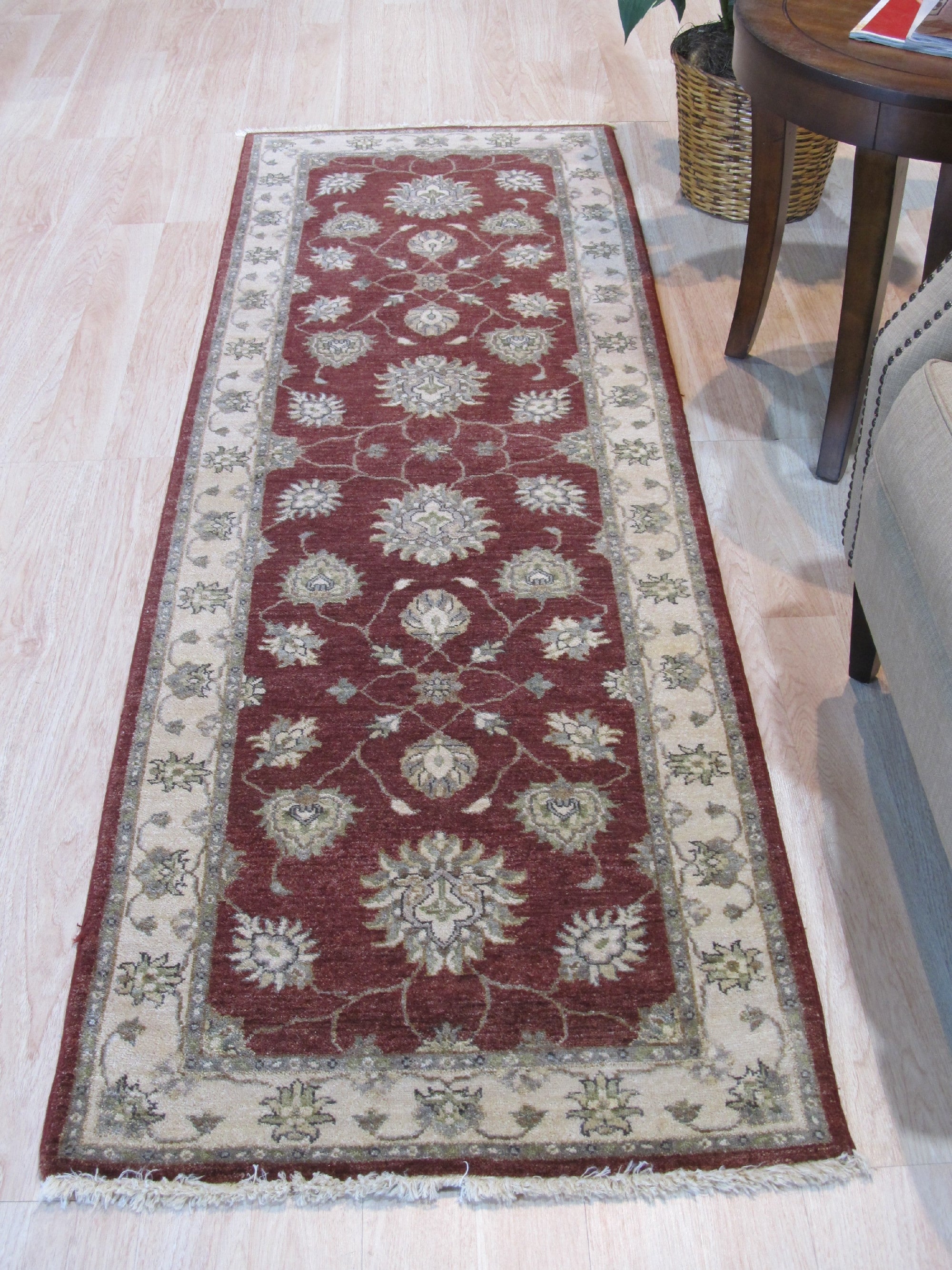 Timeless Oushak Red Hand Knotted Wool Rug displayed in a warmly lit living room setting. Rich reds and intricate floral patterns of the hand-knotted wool rug ground the space, complementing the surrounding furniture.