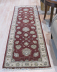 Timeless Oushak Red Hand Knotted Wool Rug displayed in a warmly lit living room setting. Rich reds and intricate floral patterns of the hand-knotted wool rug ground the space, complementing the surrounding furniture.
