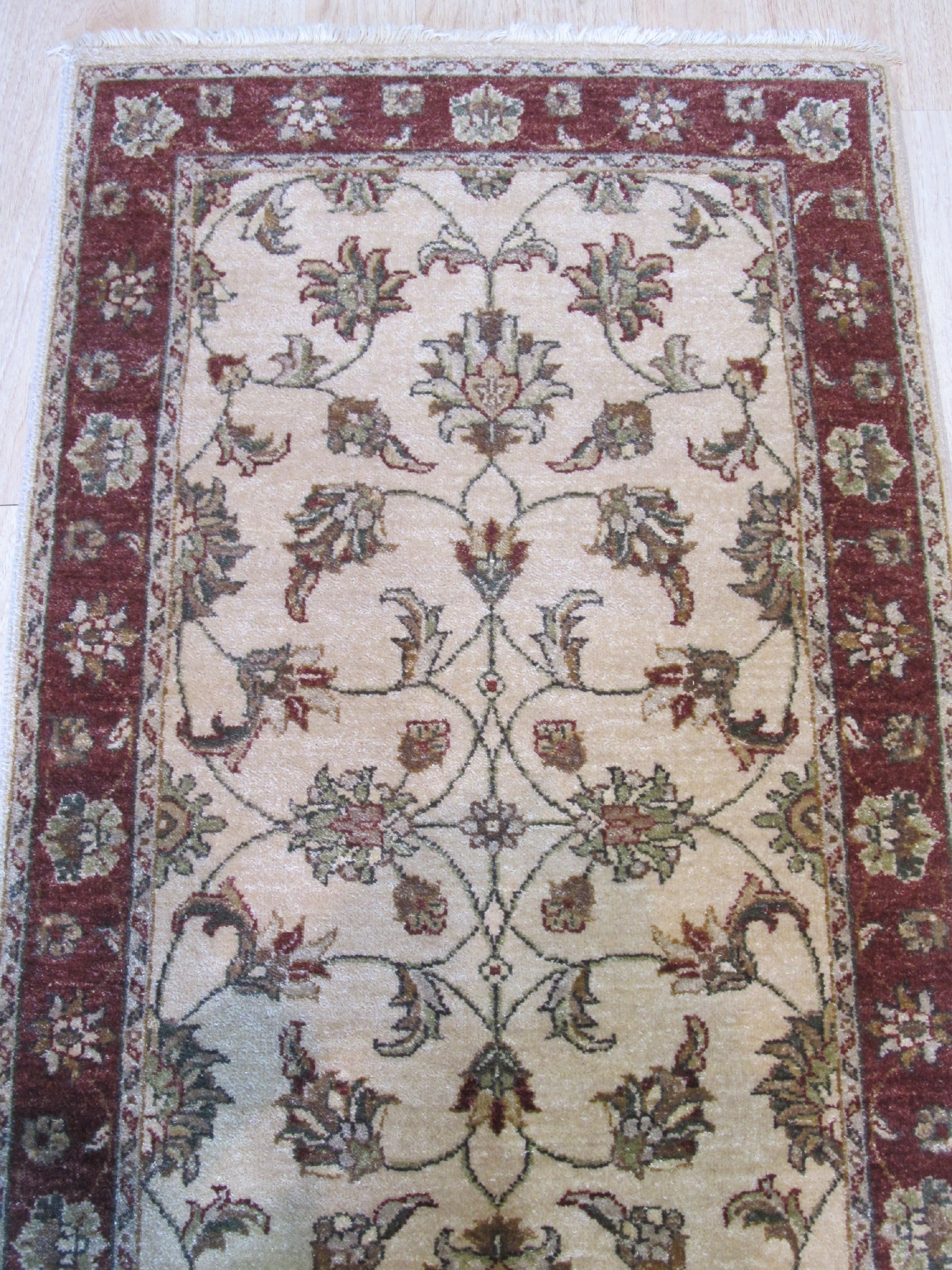 Bianca Agra Ivory Hand Knotted Wool Rug, lending warmth to a softly lit room, its hand-knotted wool texture and ivory hues creating an inviting and serene atmosphere.