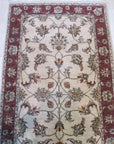 Bianca Agra Ivory Hand Knotted Wool Rug, lending warmth to a softly lit room, its hand-knotted wool texture and ivory hues creating an inviting and serene atmosphere.