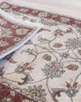 Bianca Agra Ivory Hand Knotted Wool Rug, its intricate, hand-knotted weave and elegant ivory tones lending warmth and sophisticated texture to a well-lit living room.