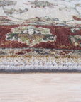Bianca Agra Ivory Hand Knotted Wool Rug, its intricate hand-knotted texture and subtle ivory hues lending an air of understated elegance to a softly lit living space.
