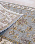 Zinnia Agra Green Hand Knotted Wool Rug, a lush expanse of verdant green wool, hand-knotted with intricate floral patterns, bringing warmth and artisanal craftsmanship to an inviting living space.