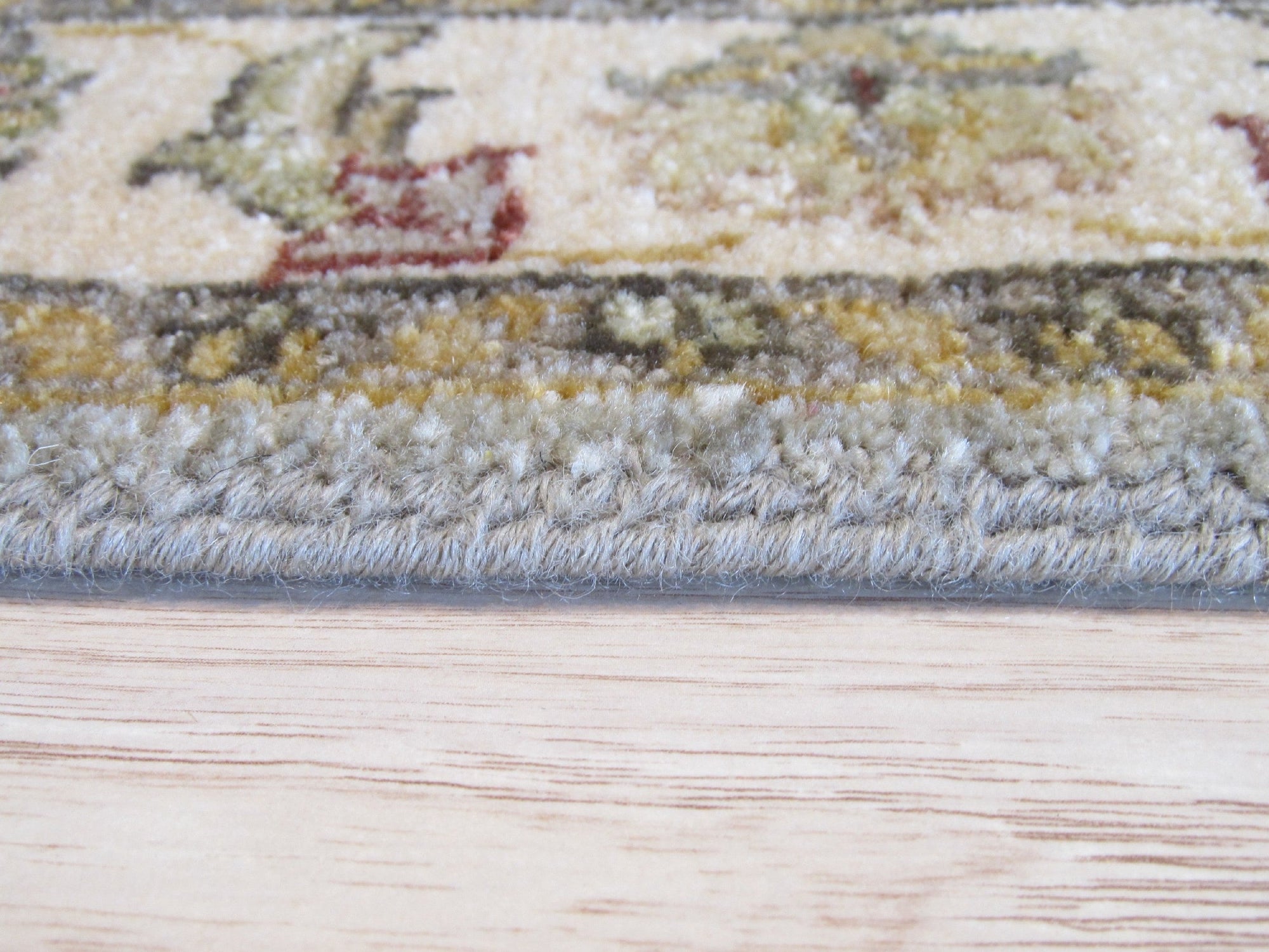 Zinnia Agra Green Hand Knotted Wool Rug, showcasing its intricate floral pattern in vibrant greens and subtle earth tones, enriching a warmly lit living space.