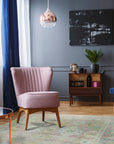 Timeless Oushak Pink Hand Knotted Wool Rug, featuring a delicate floral pattern in soft pink and cream hues, seen in a bright, modern living room setting.