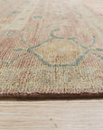 Timeless Oushak Pink Hand Knotted Wool Rug, its soft pink hues and intricate Oushak patterns accentuating a living room space with warm, inviting textures and natural light.
