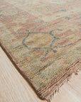 Timeless Oushak Pink Hand Knotted Wool Rug, soft blush hues and intricate floral motifs dance across this hand-knotted wool rug, lending an elegant and inviting warmth to a bright living space.