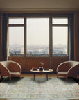 Timeless Oushak Pink Hand Knotted Wool Rug, showcasing its soft pink hue and intricate, traditional Oushak design, rests elegantly on a light wood floor.
