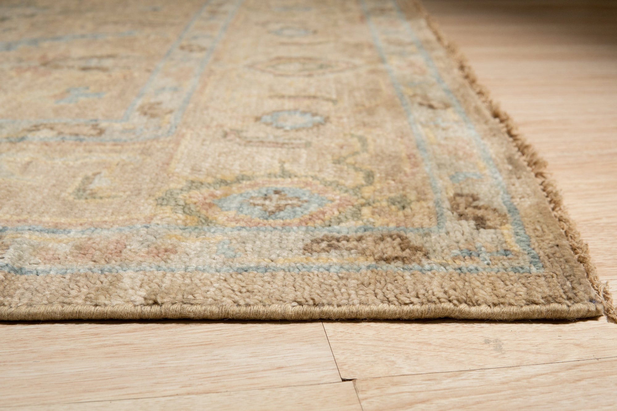Captivating Traditional Beige Hand Knotted Wool Rug, beige and wool floor covering featuring intricate traditional patterns, lying flat, viewed in a room setting.