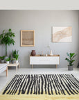 Mira Iris Yellow Hand Knotted Wool Rug, its vibrant yellow hues and intricate hand-knotted wool construction displayed within a well-lit interior setting.