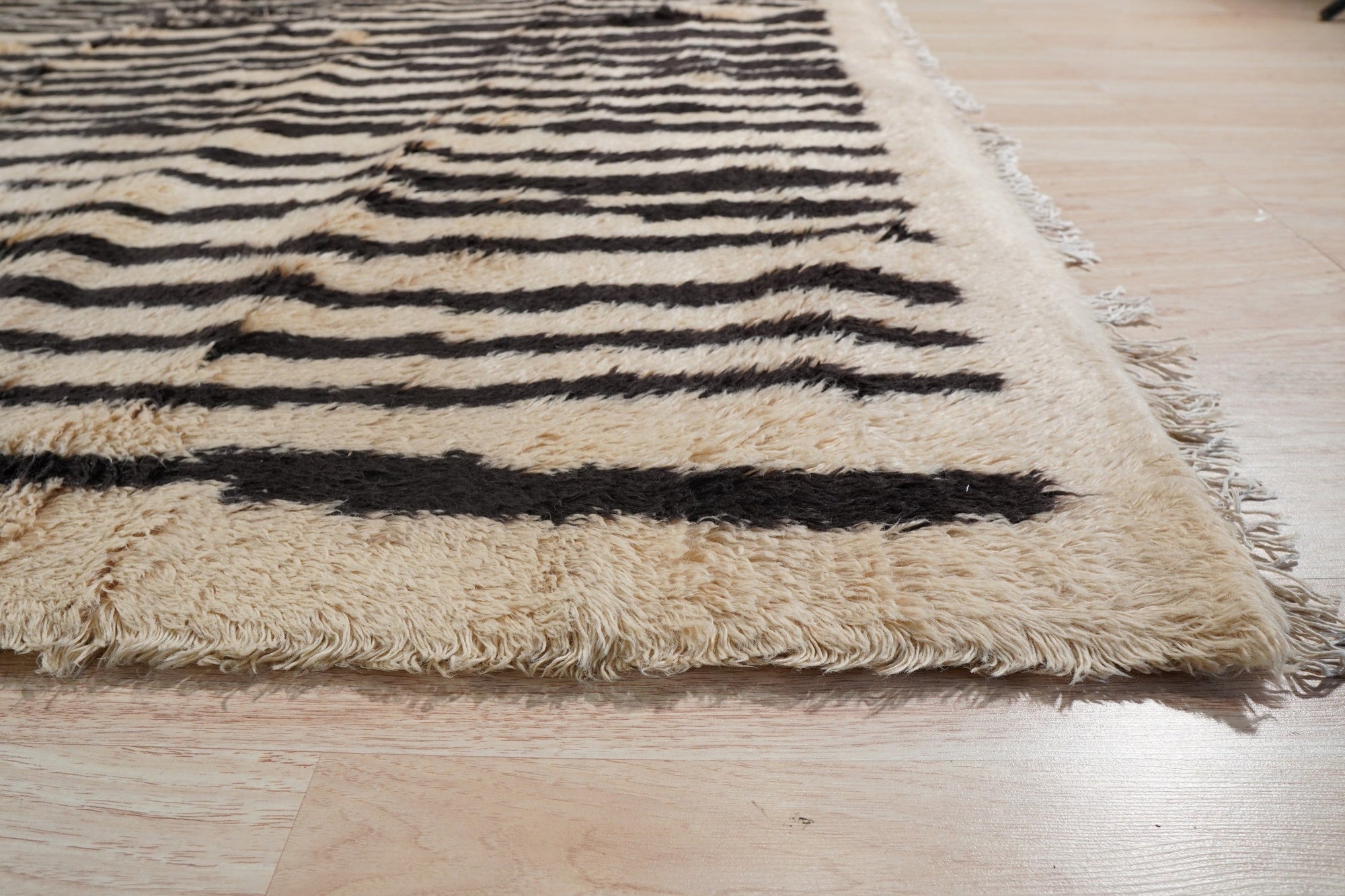 Mira Iris Yellow Hand Knotted Wool Rug, bursts with sunny warmth, its hand-knotted wool construction evident in the intricate detail, softening a modern interior.