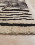 Mira Iris Yellow Hand Knotted Wool Rug, bursts with sunny warmth, its hand-knotted wool construction evident in the intricate detail, softening a modern interior.