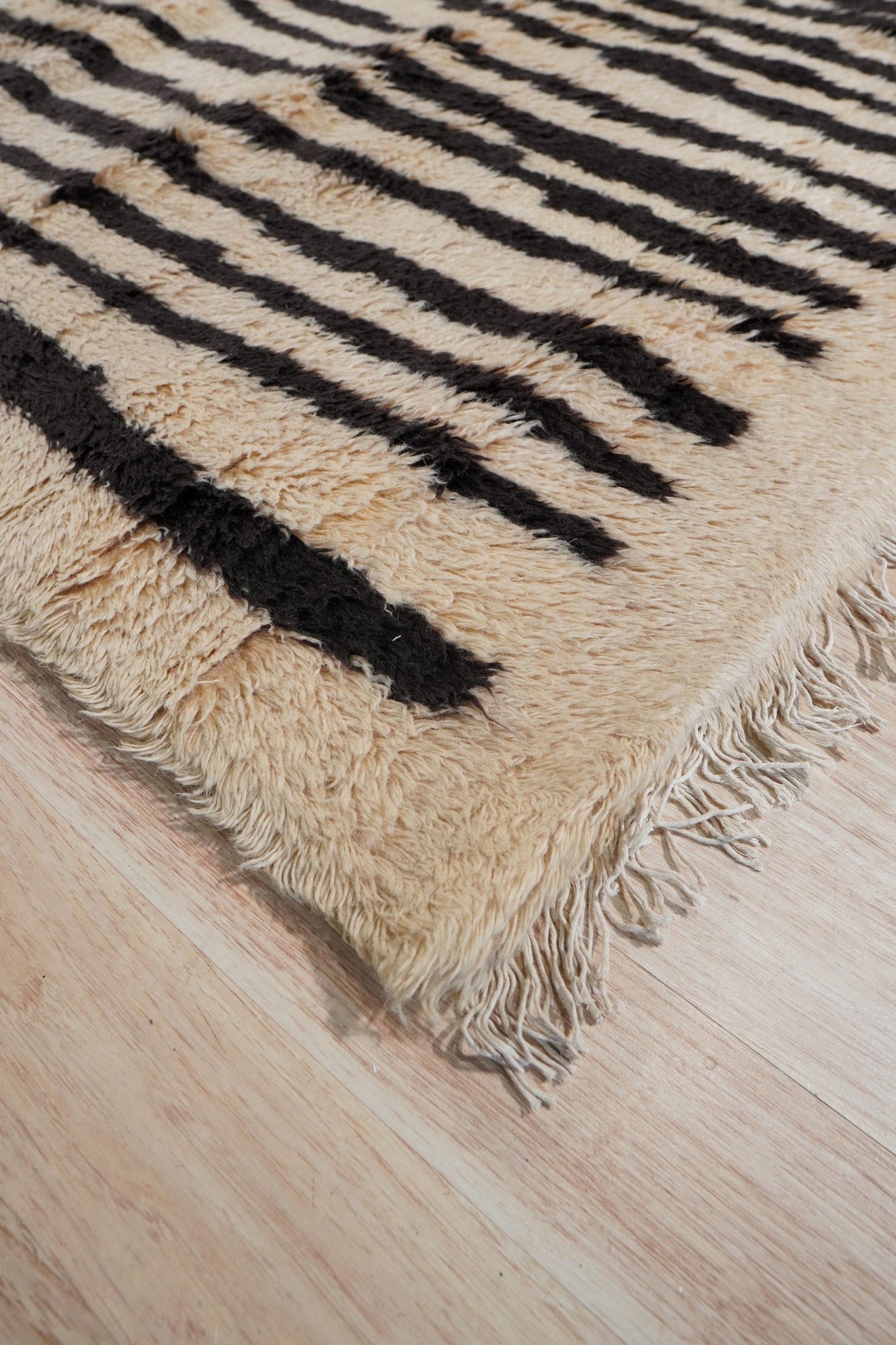 Mira Iris Yellow Hand Knotted Wool Rug, vibrant yellows and subtle iris hues blend in this hand-knotted wool rug, enhancing a brightly lit room with its artisanal construction and intricate design.
