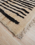 Mira Iris Yellow Hand Knotted Wool Rug, vibrant yellows and subtle iris hues blend in this hand-knotted wool rug, enhancing a brightly lit room with its artisanal construction and intricate design.