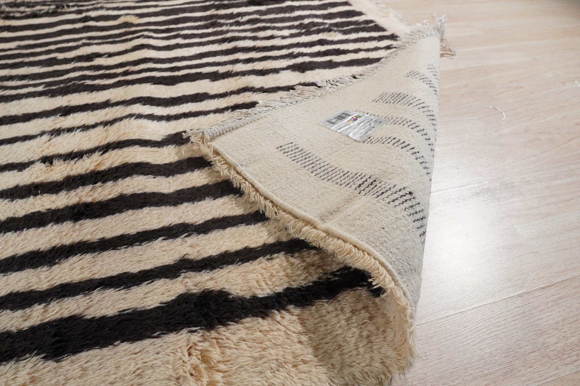 Mira Iris Yellow Hand Knotted Wool Rug, vibrant yellow wool rug with an intricate, possibly abstract, floral-inspired design, displayed in a bright and airy living space.