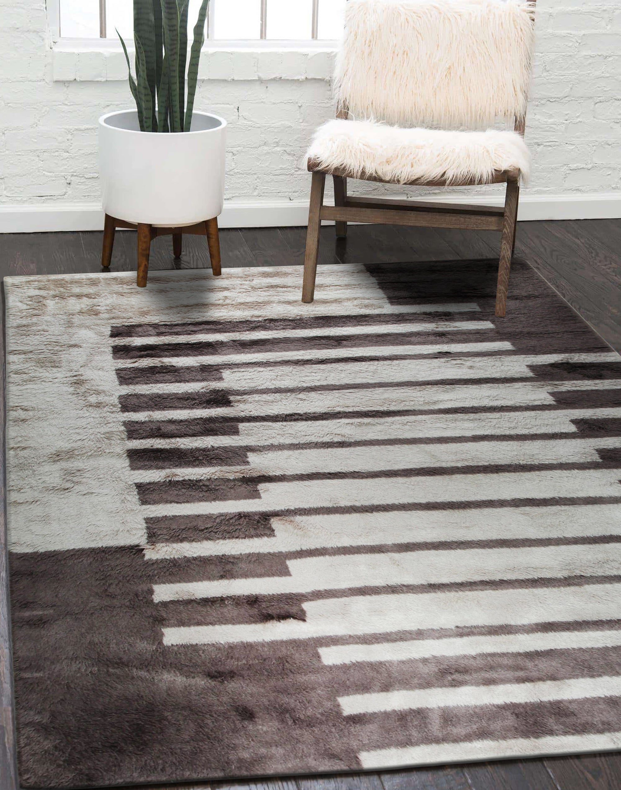 Nadia Mira Brown Hand Knotted Wool Rug, showcasing its intricate hand-knotted construction with rich brown hues and a detailed traditional pattern, displayed within a warmly lit living room setting.
