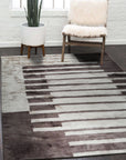 Nadia Mira Brown Hand Knotted Wool Rug, showcasing its intricate hand-knotted construction with rich brown hues and a detailed traditional pattern, displayed within a warmly lit living room setting.