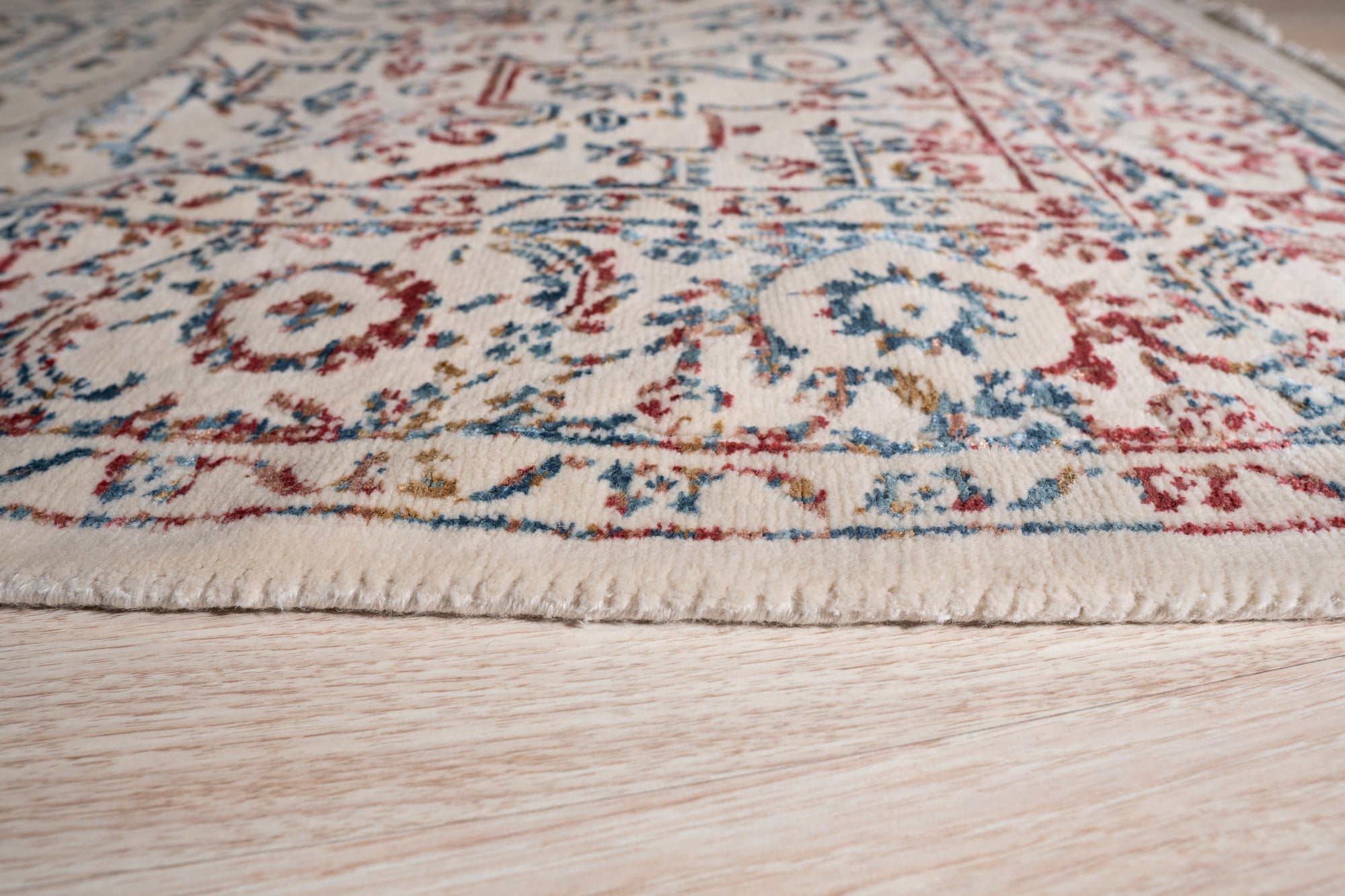 Lila Chic Multicolor Hand Knotted Wool & Viscose Rug, showcasing a vibrant blend of colors in a textured wool and viscose weave, fills the frame with its intricate hand-knotted design.