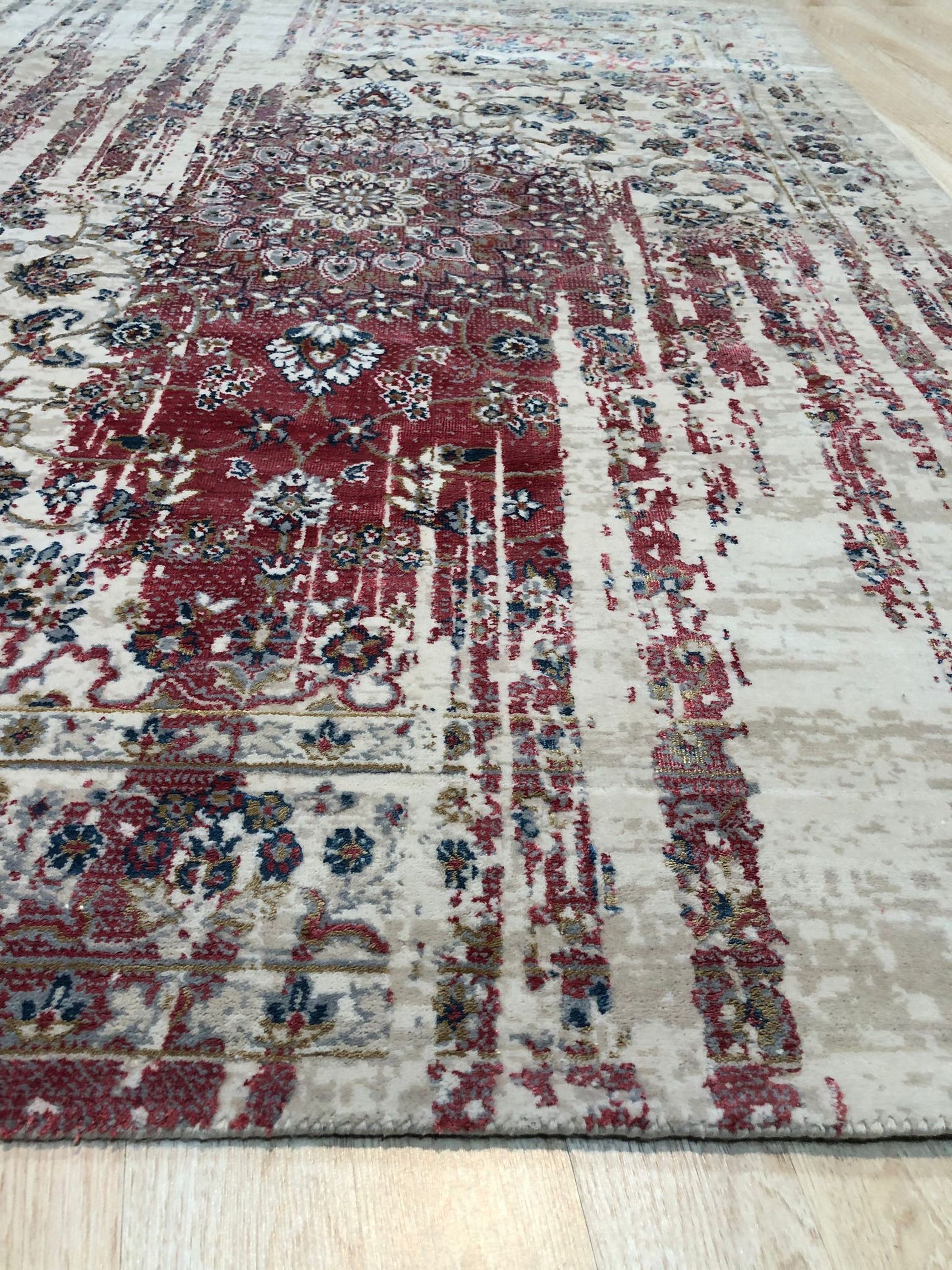 Exquisite Bianca Red Machine Made Wool & Viscose Rug, blending rich red hues and subtle viscose sheen, lays flat highlighting its intricate machine-made weave and elegant design in a room setting.