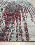 Exquisite Bianca Red Machine Made Wool & Viscose Rug, blending rich red hues and subtle viscose sheen, lays flat highlighting its intricate machine-made weave and elegant design in a room setting.