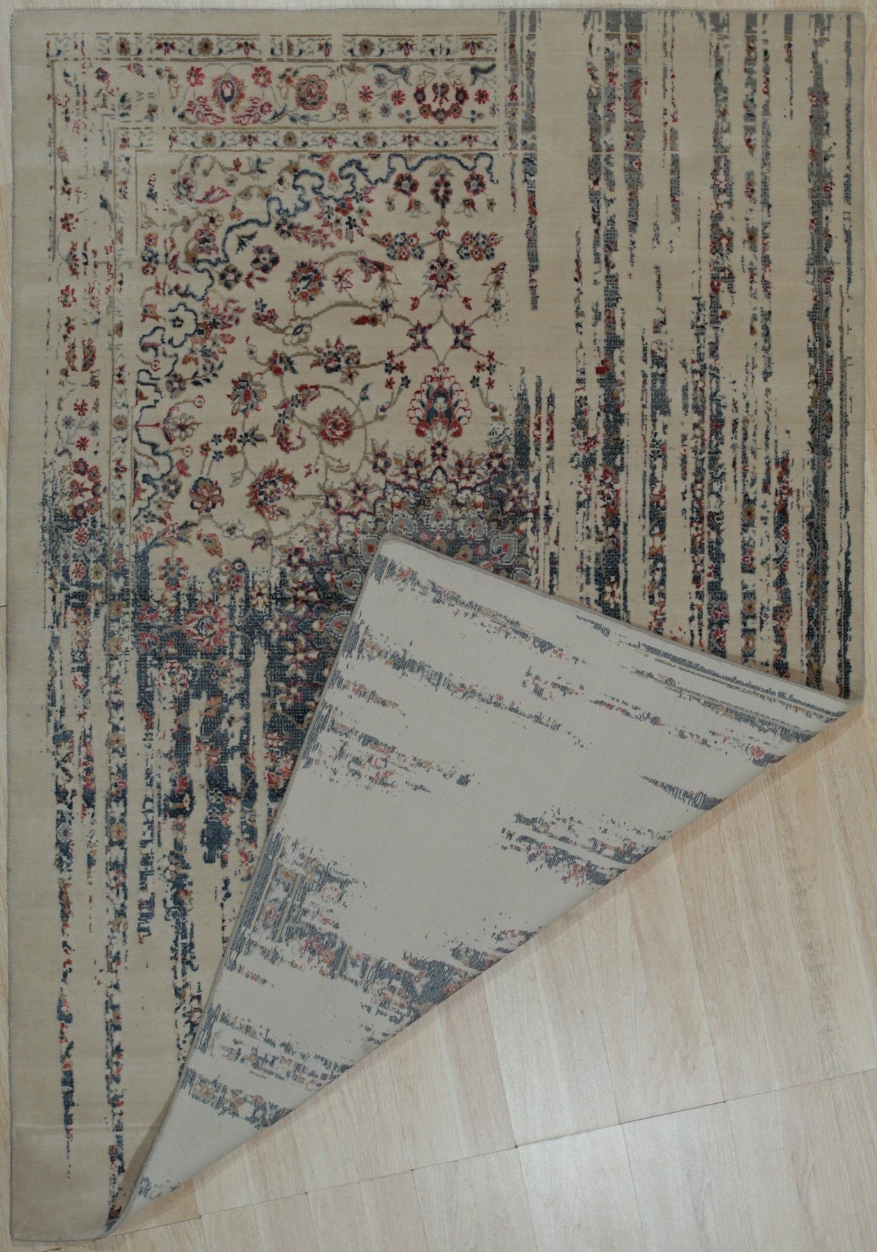 Penelope Elegant Teal Machine Made Wool & Viscose Rug, its luxurious teal and subtle sheen catching the light, lies gracefully on a light wood floor, showcasing its intricate, timeless pattern and inviting texture.