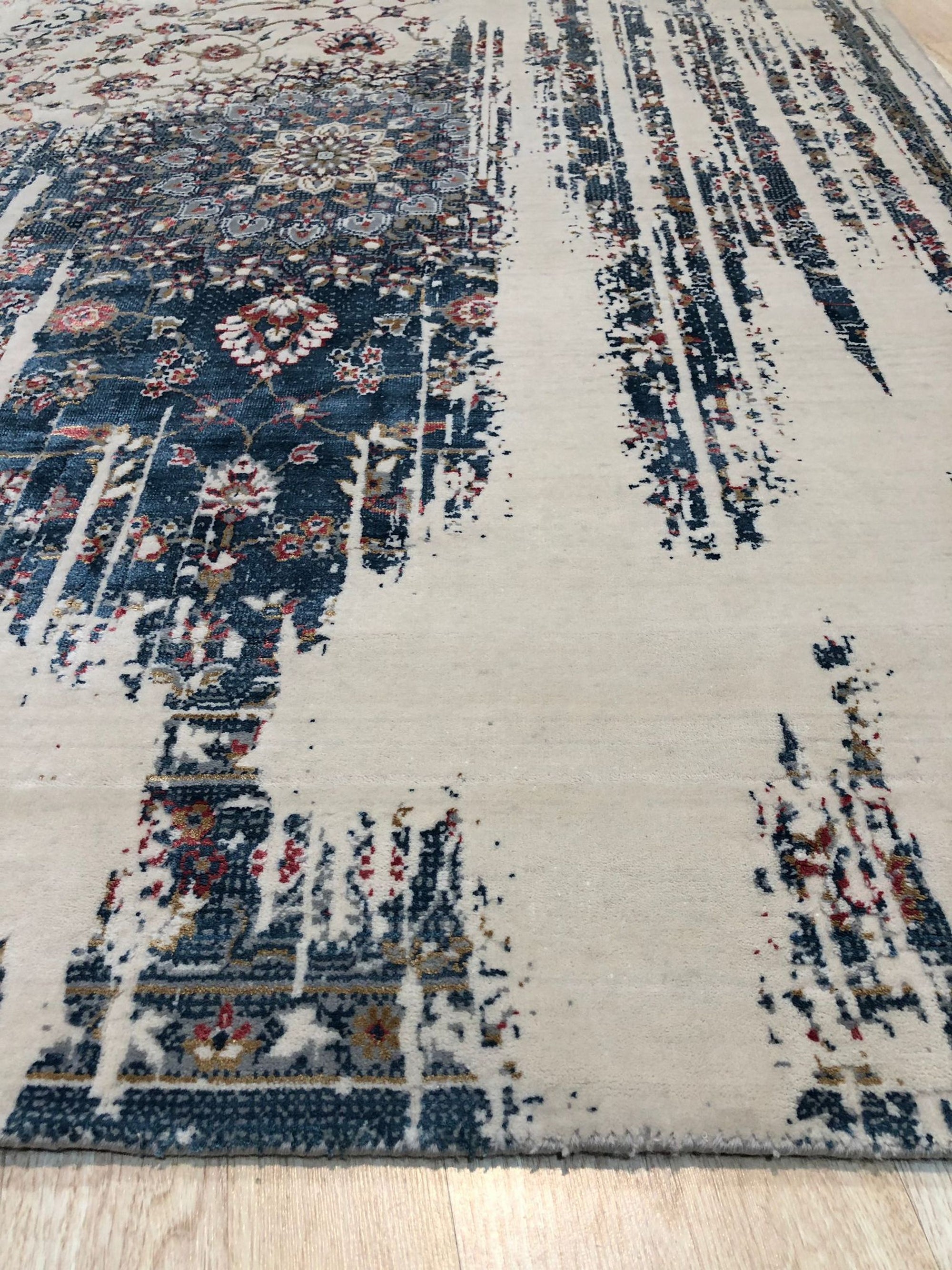 Penelope Elegant Teal Machine Made Wool & Viscose Rug, swirling patterns dance in teal and subtle neutrals, showcasing its soft texture and machine-made construction within a warmly lit room setting.