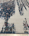 Penelope Elegant Teal Machine Made Wool & Viscose Rug, swirling patterns dance in teal and subtle neutrals, showcasing its soft texture and machine-made construction within a warmly lit room setting.
