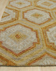 Alluring Laine Gold Hand Tufted Wool Rug, a plush wool rug with subtle gold tones and a textured hand-tufted construction, adding warmth and elegance to a living room setting.