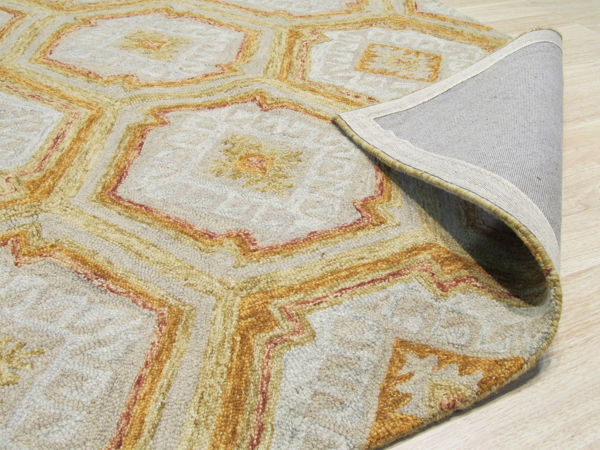Alluring Laine Gold Hand Tufted Wool Rug, featuring warm gold tones and subtle textures, complements a modern living room with neutral furniture and ample natural light.
