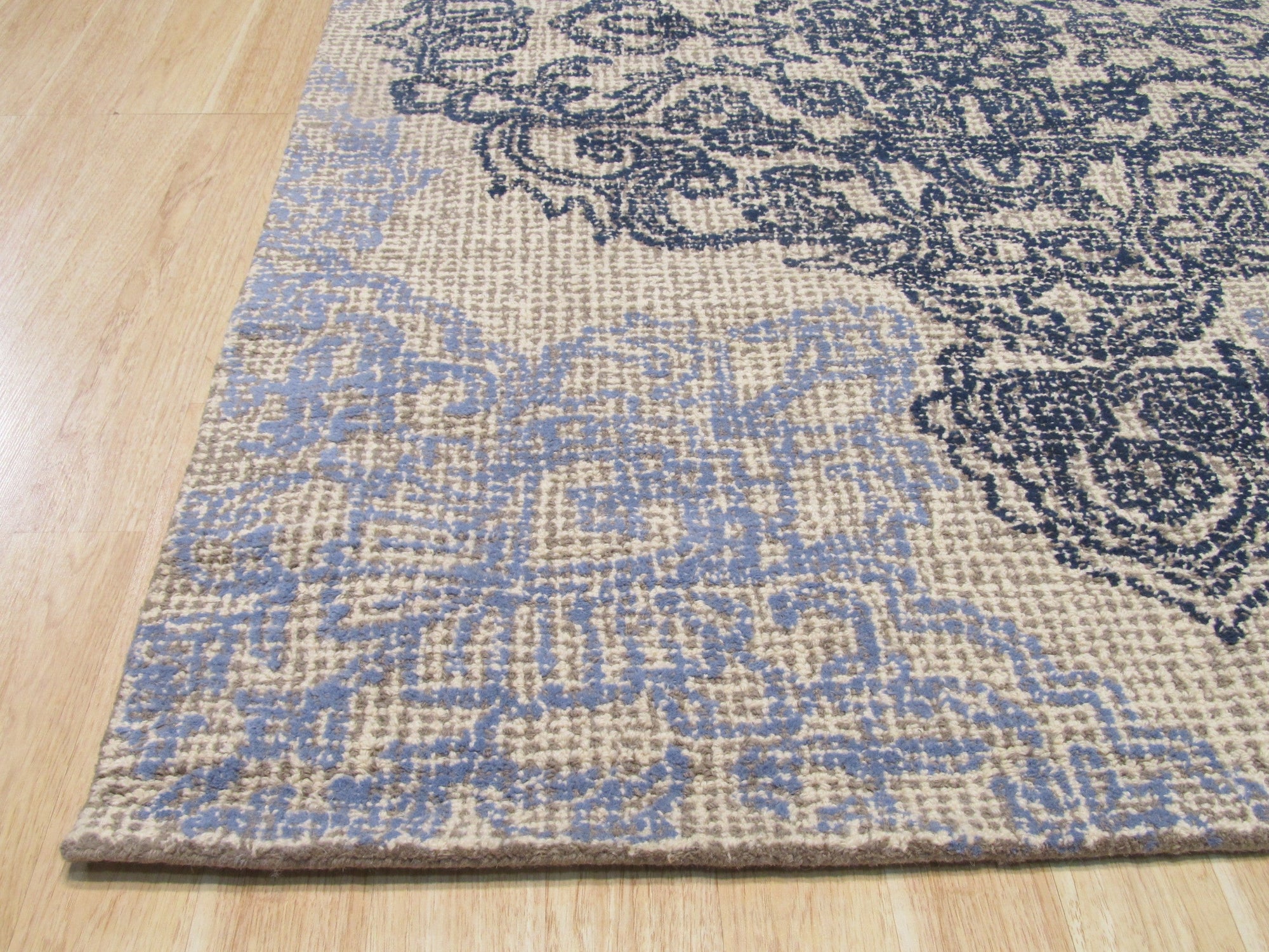 Rustic Stylish Beige Hand Tufted Wool Rug, its textured beige field adding warmth to a naturally lit space, inviting comfort underfoot.