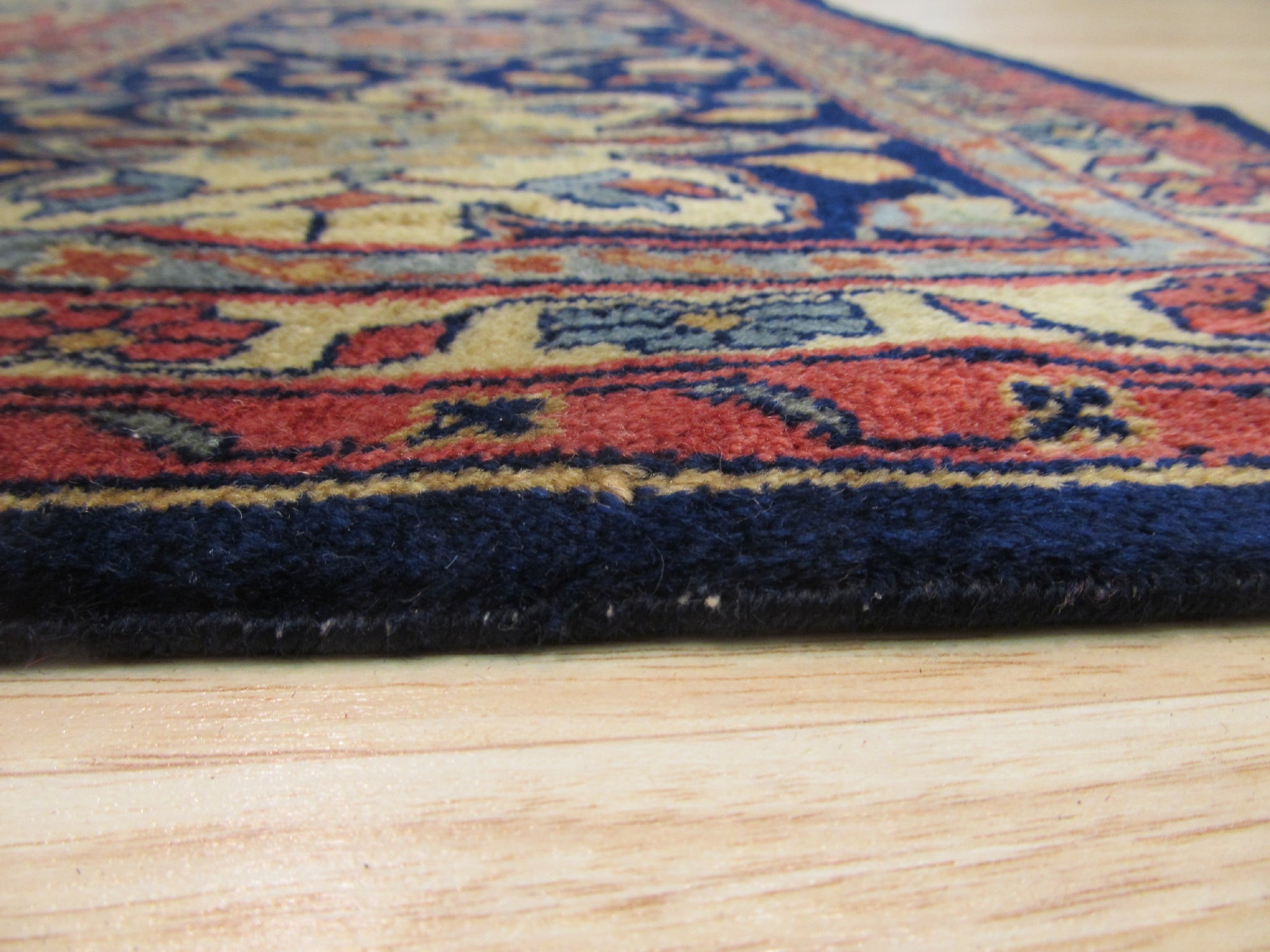 Classic Traditional Multicolor Hand Knotted Wool Rug, displaying vibrant hues and intricate hand-knotted construction, rests elegantly on a polished hardwood floor.