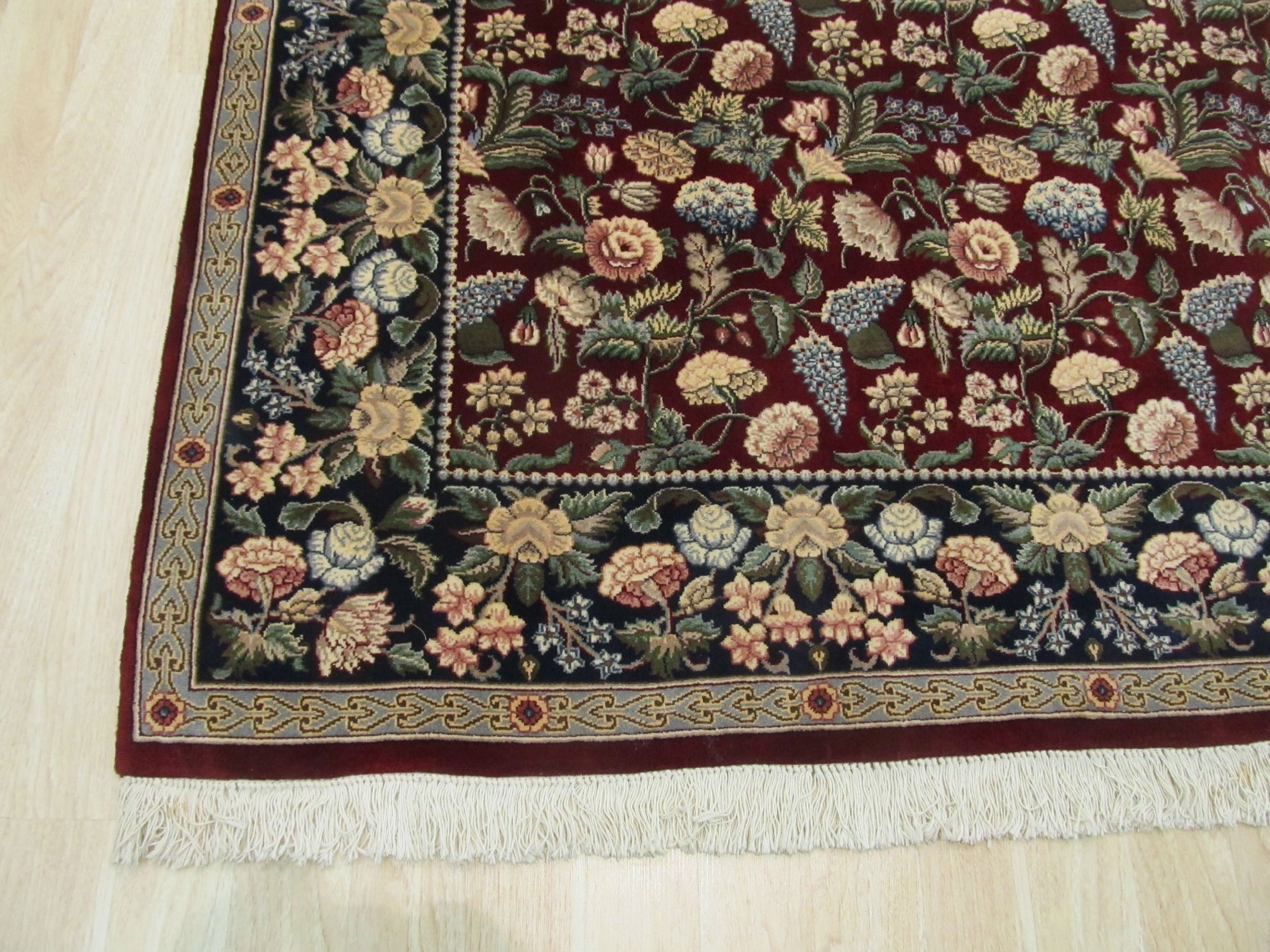 Delicate Traditional Multicolor Hand Knotted Wool Rug, vibrant hues and intricate patterns dancing across its hand-knotted wool surface, fills the frame with warmth and texture.
