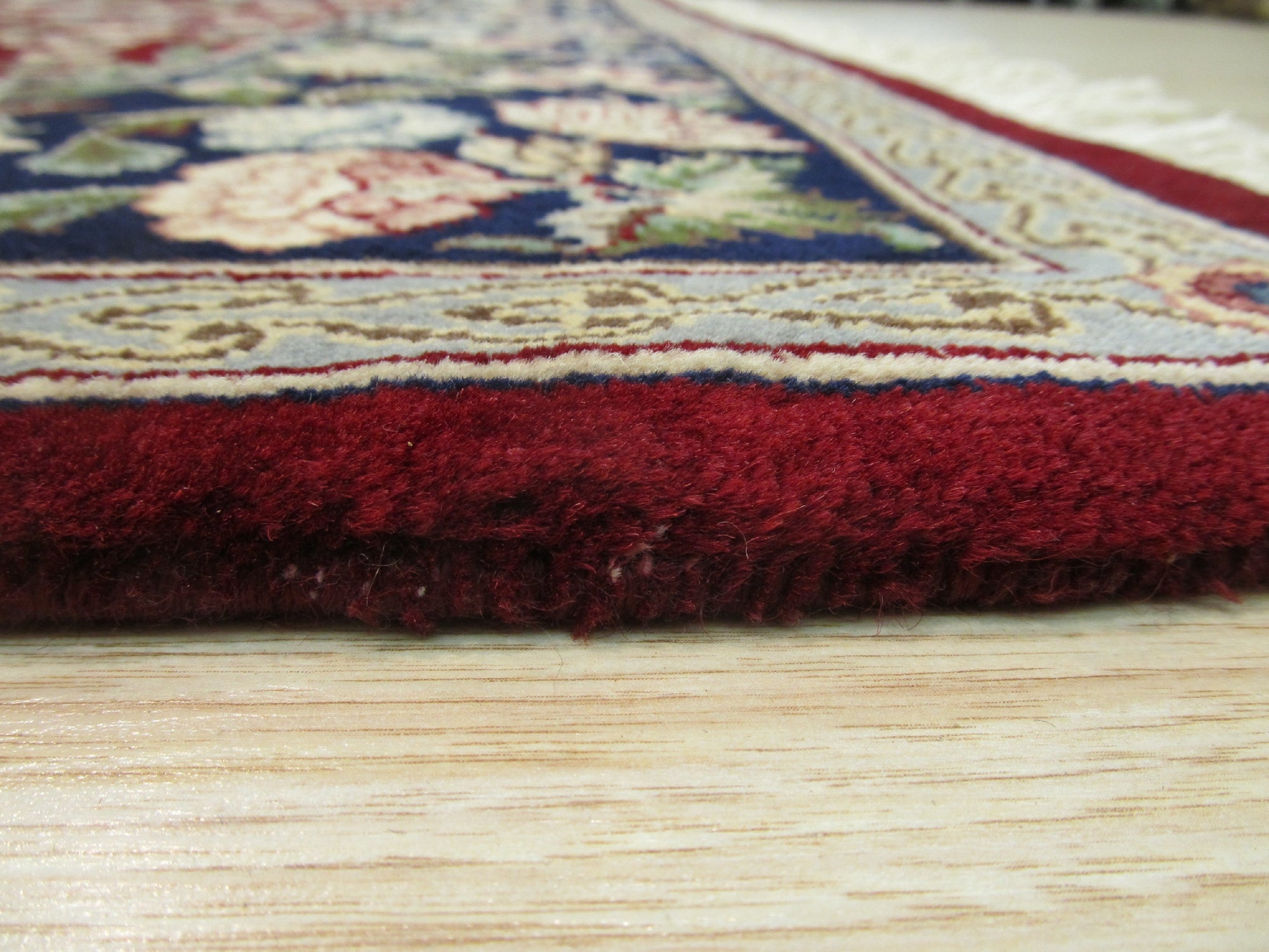 Delicate Traditional Multicolor Hand Knotted Wool Rug displayed, showcasing intricate patterns in a blend of vibrant hues, highlighting its wool construction and hand-knotted quality.