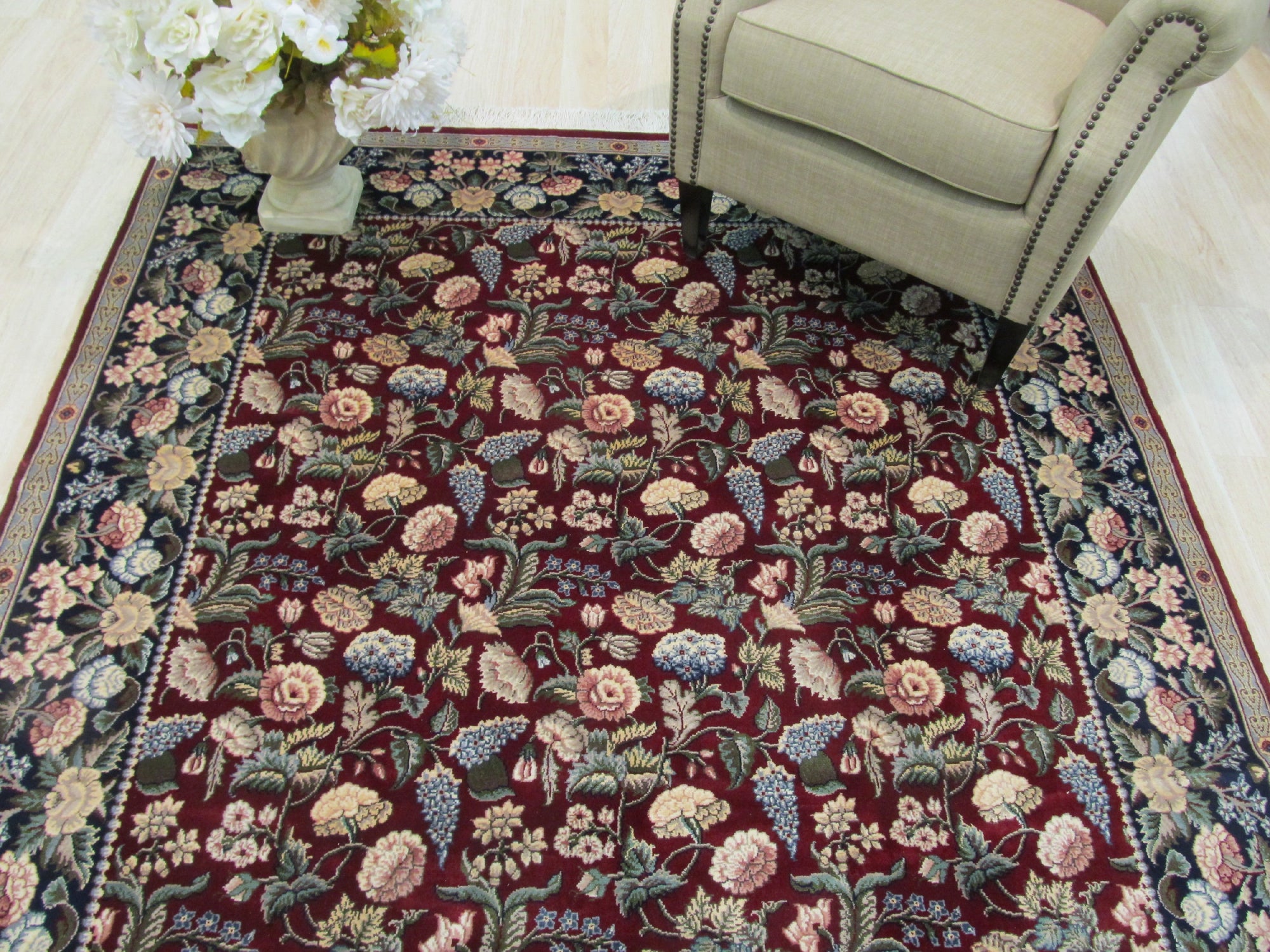 Delicate Traditional Multicolor Hand Knotted Wool Rug, vibrant hues dance across hand-knotted wool, showcasing intricate traditional patterns within a warmly lit room.