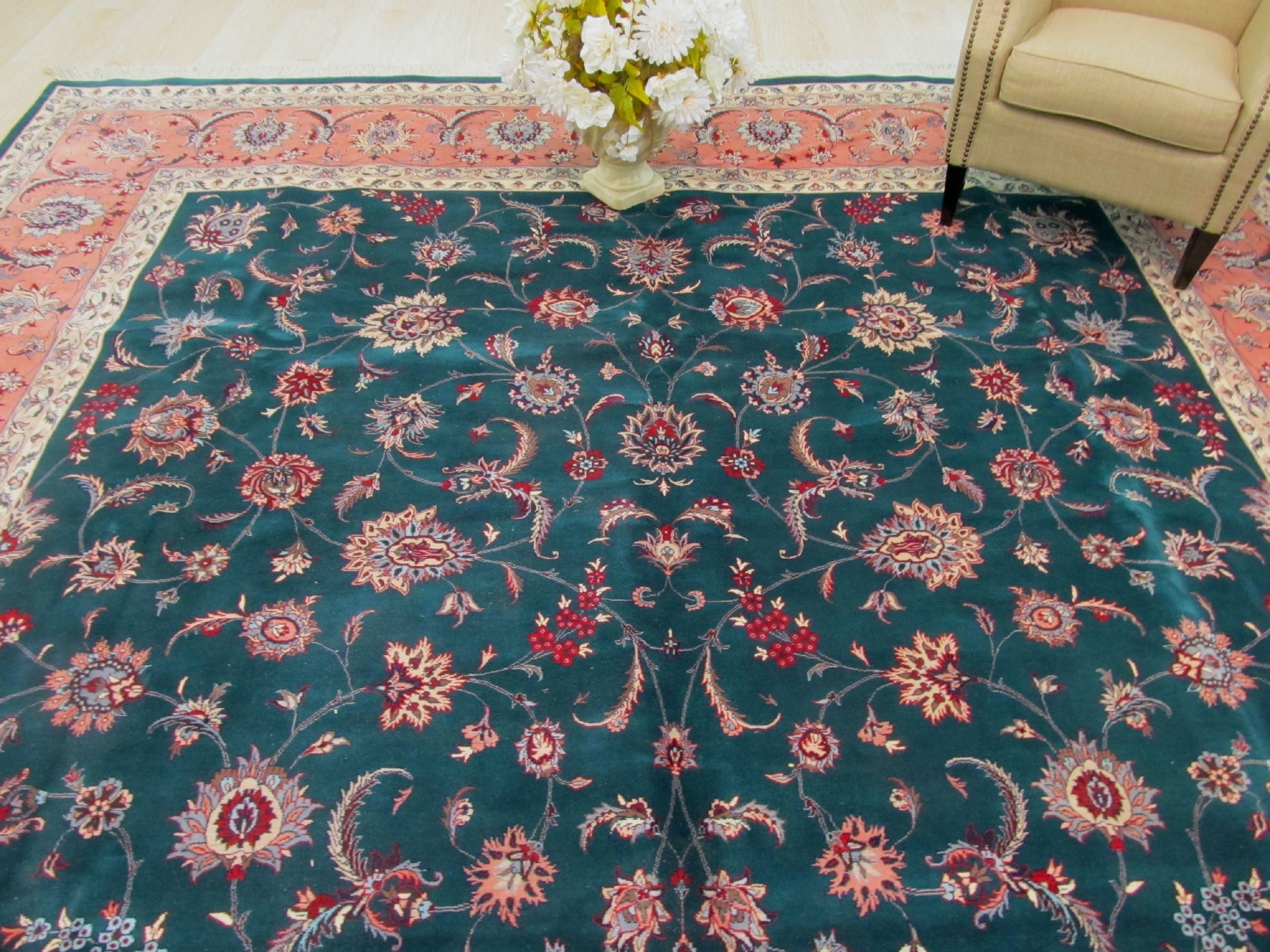 Trara Jasmine Multicolor Hand Knotted Wool Rug featuring a vibrant, intricate design with blooming floral motifs and geometric accents, showcased within a bright, modern living room setting.