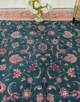 Para Jasmine Multicolor Hand Knotted Wool Rug displayed in a living room setting, its vibrant colors and intricate hand-knotted details adding warmth and texture to the space.